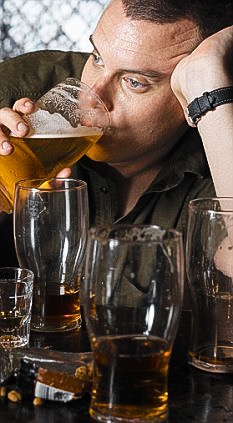 Man Getting Drunk at Pub --- Image by © David Vintiner/zefa/Corbis